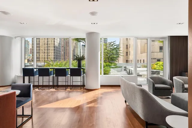 a living room with furniture and a floor to ceiling window