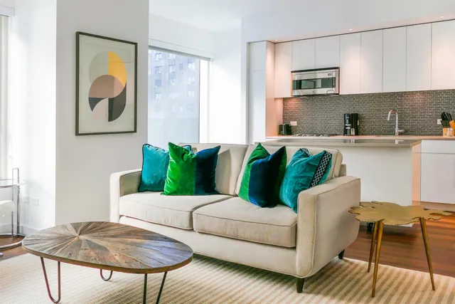 a living room with furniture a rug and a painting on the wall