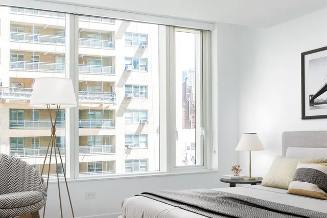 a bathroom with a sink mirror and a shower