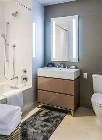a bathroom with a sink toilet and shower