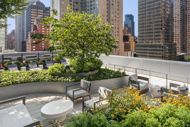 a backyard of a house with outdoor seating