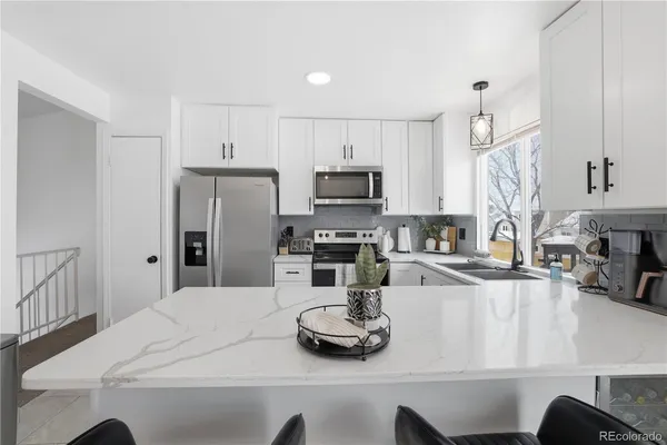 a stove top oven sitting inside of a kitchen
