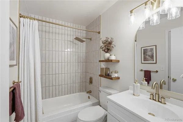a view of a room with a bathtub and chandelier