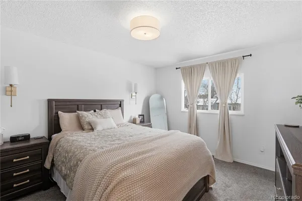 a bedroom with a bed and a desk