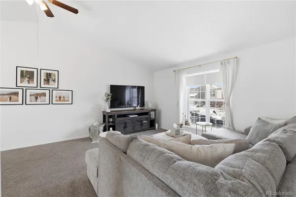 a living room with furniture and a chandelier