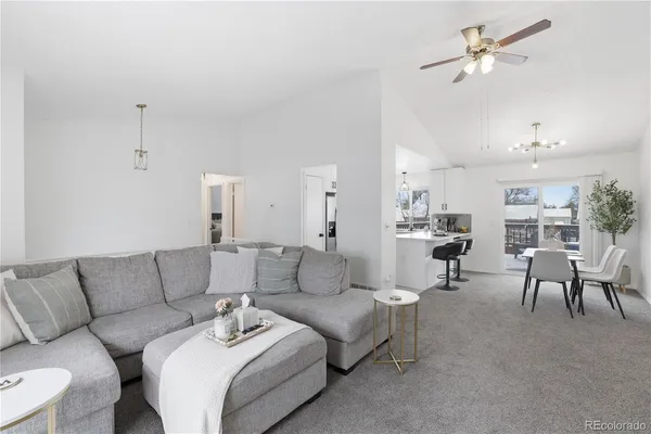 a living room with furniture and a chandelier