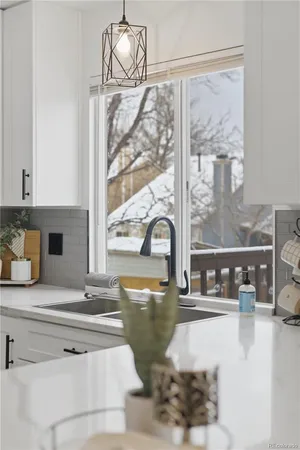a kitchen with a dining table chairs and refrigerator