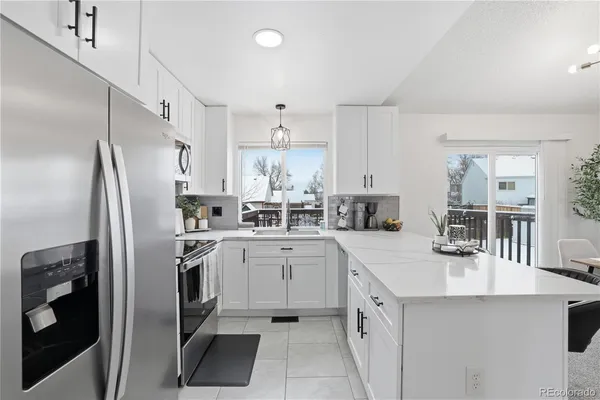 a kitchen with granite countertop a sink appliances and cabinets