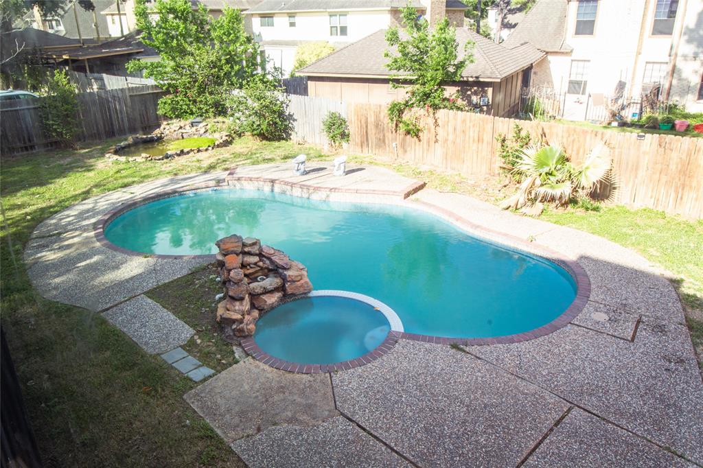 a view of a swimming pool in the backyard