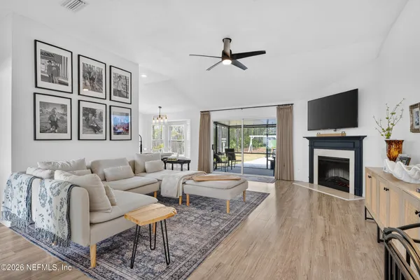 a living room with furniture a fireplace and a flat screen tv