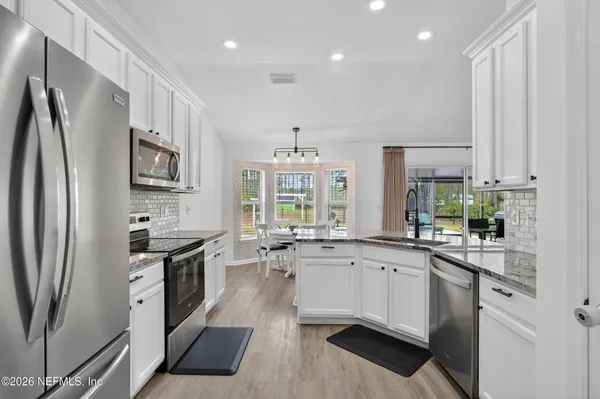 a kitchen with stainless steel appliances a sink stove and refrigerator