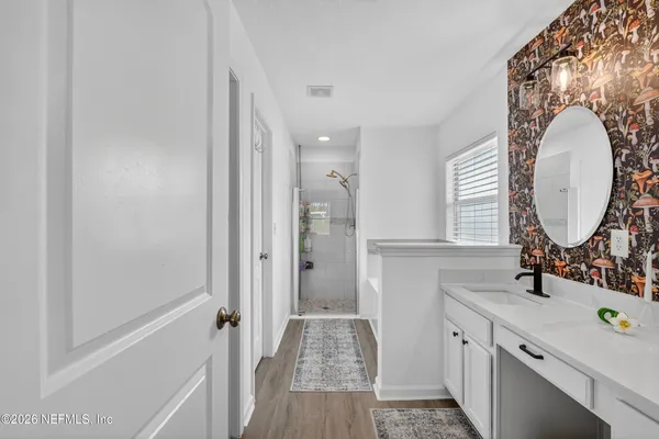 a bathroom with a double vanity sink and a mirror