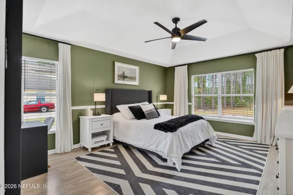 a bedroom with a bed and a large window