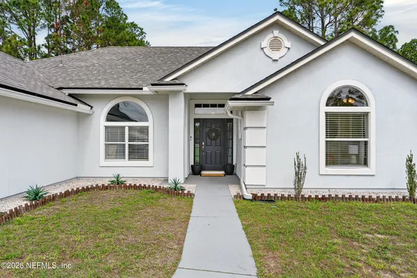 a front view of a house with a yard