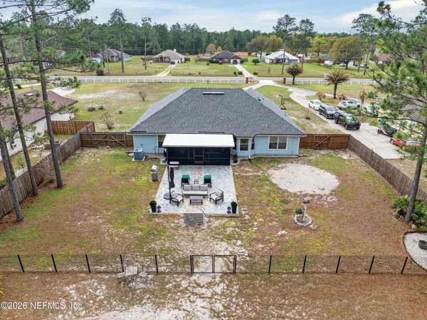 an aerial view of residential houses with outdoor space
