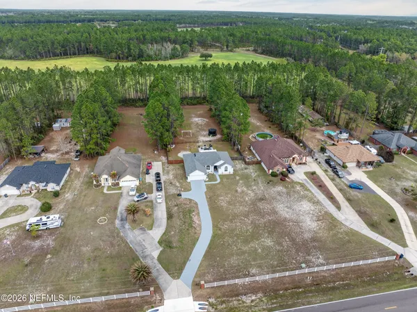 an aerial view of a house with a yard and lake view