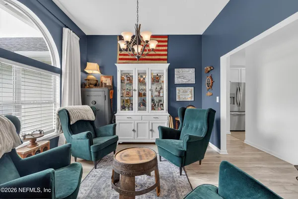 a living room with furniture a rug and a window