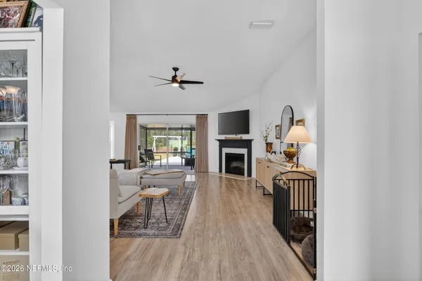 a living room with furniture and a wooden floor