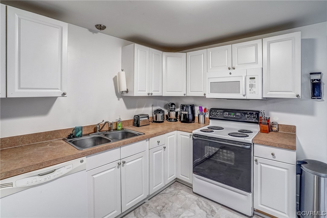 3312 Hawkins Road Henrico, VA 23228 - Photo 18 of 32 a kitchen with cabinets appliances a sink and a counter top