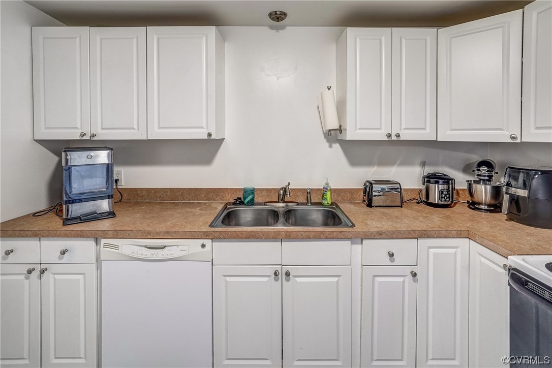 3312 Hawkins Road Henrico, VA 23228 - Photo 19 of 32 a kitchen with white cabinets and white appliances