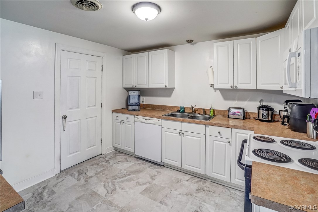3312 Hawkins Road Henrico, VA 23228 - Photo 20 of 32 a kitchen with white cabinets and white appliances