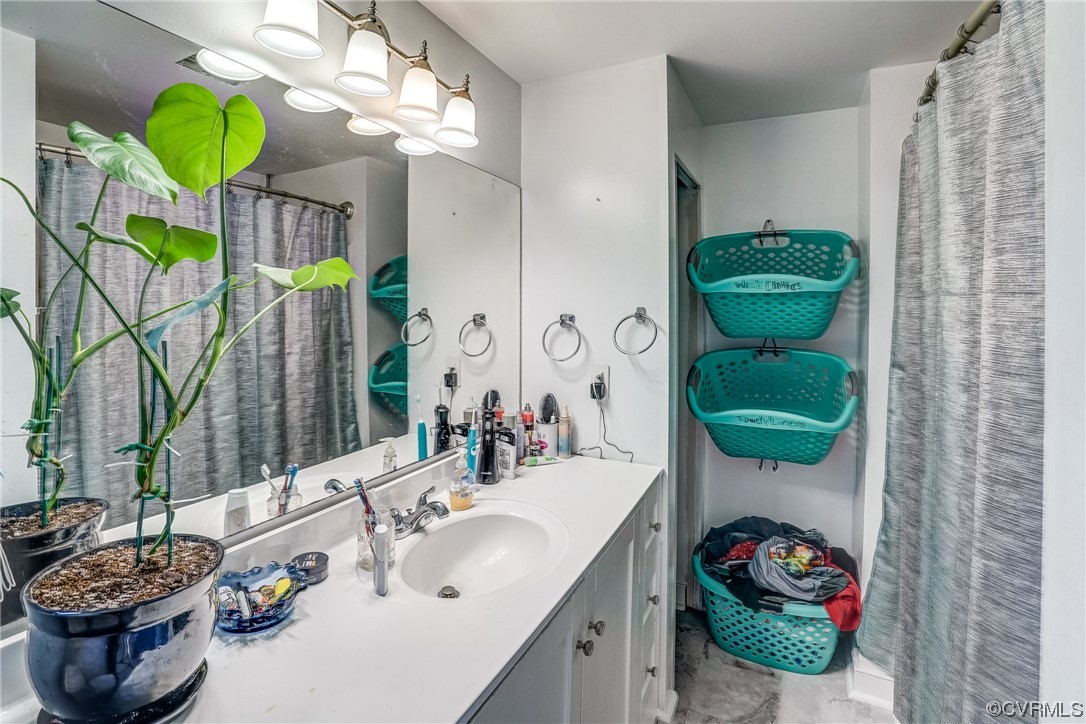 3312 Hawkins Road Henrico, VA 23228 - Photo 22 of 32 a bathroom with a sink a mirror and a bathtub