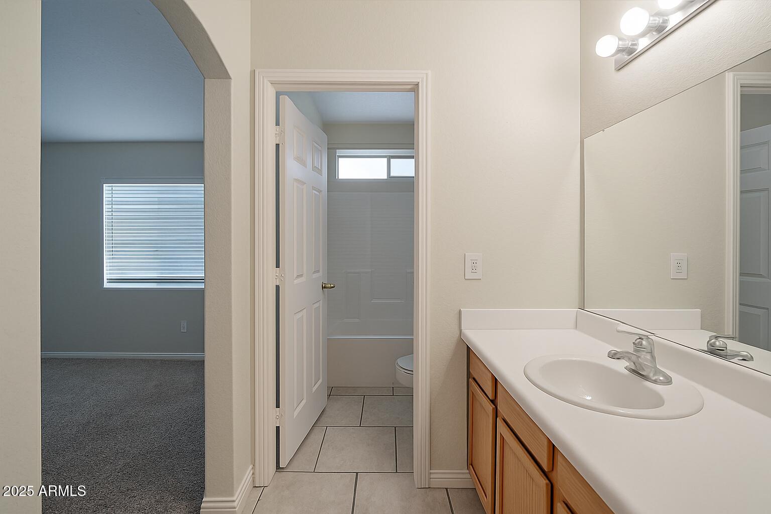 23993 West Pecan Road Buckeye, AZ 85326 - Photo 11 of 12 a bathroom with a sink and a mirror