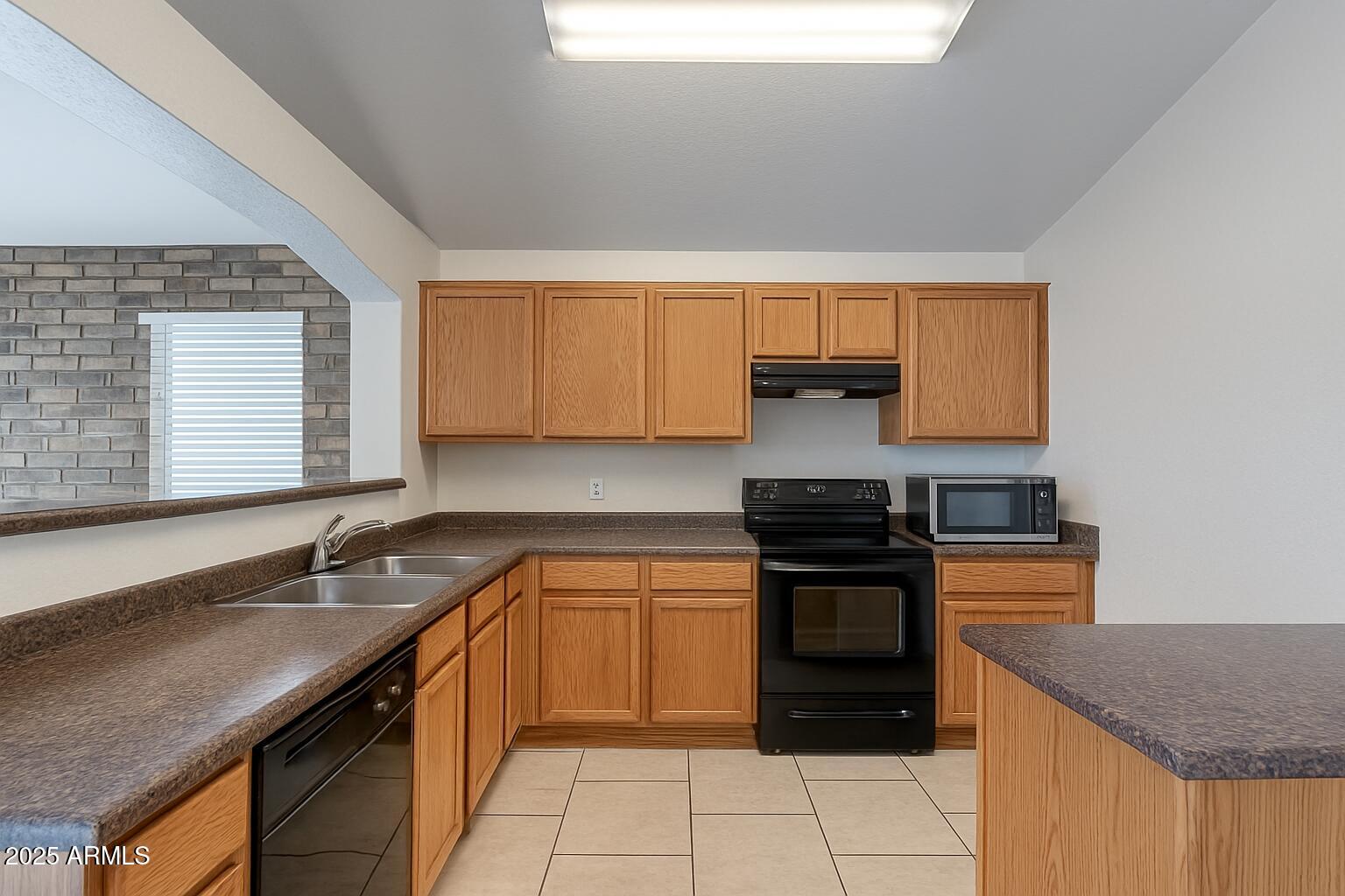23993 West Pecan Road Buckeye, AZ 85326 - Photo 3 of 12 a kitchen with a sink stove and cabinets