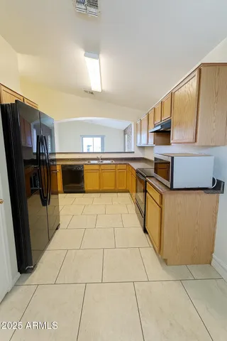a kitchen with stainless steel appliances granite countertop a sink and cabinets