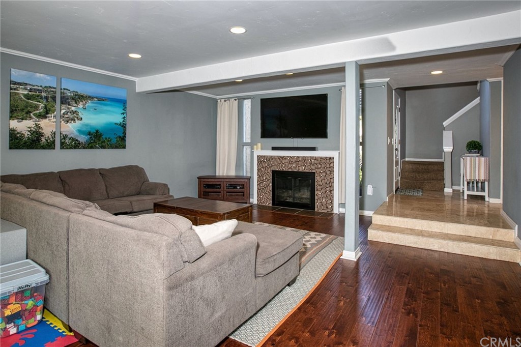 7314 East Equitation Way Orange, CA 92869 - Photo 12 of 37 a living room with furniture a flat screen tv and a fireplace