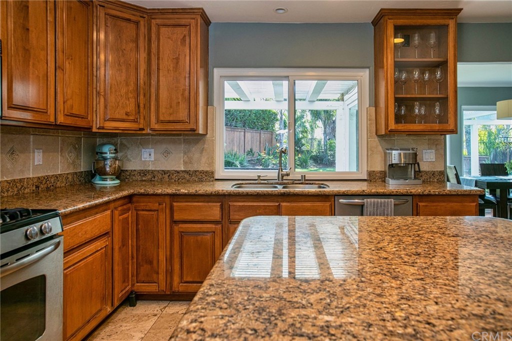 7314 East Equitation Way Orange, CA 92869 - Photo 14 of 37 a kitchen with stainless steel appliances granite countertop a stove a sink dishwasher and cabinets with wooden floor