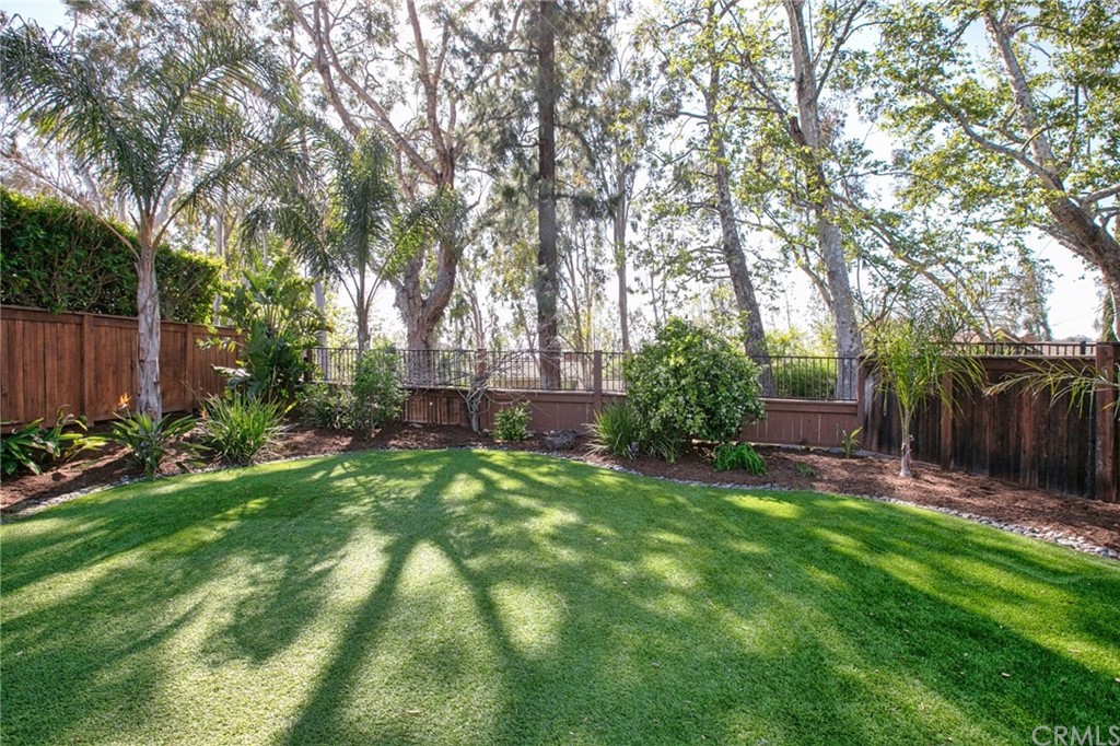7314 East Equitation Way Orange, CA 92869 - Photo 6 of 37 a view of a backyard with large trees and wooden fence