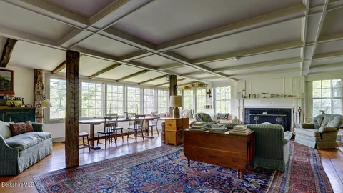 a living room with furniture fireplace and a table
