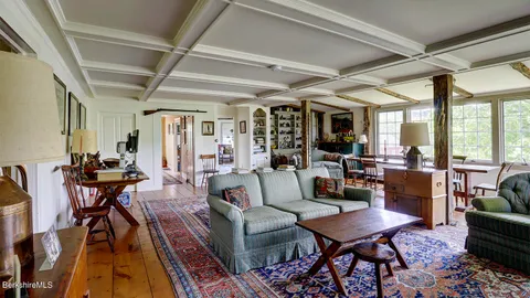 a living room with furniture wooden floor and a table