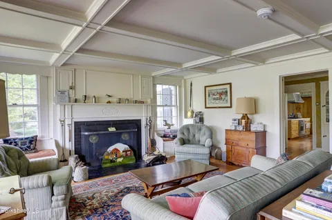 a living room with furniture a fireplace and a window