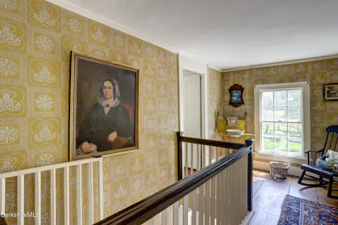 a view of a porch with wooden floor and furniture