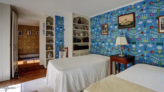 a bedroom with a bed and a bookshelf