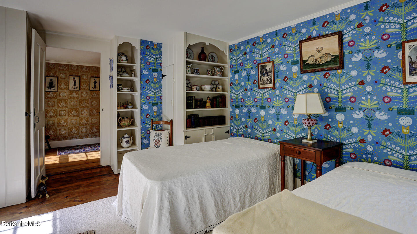 185 Keyes Hill Road New Marlborough, MA 01259 - Photo 25 of 49 a bedroom with a bed and a bookshelf