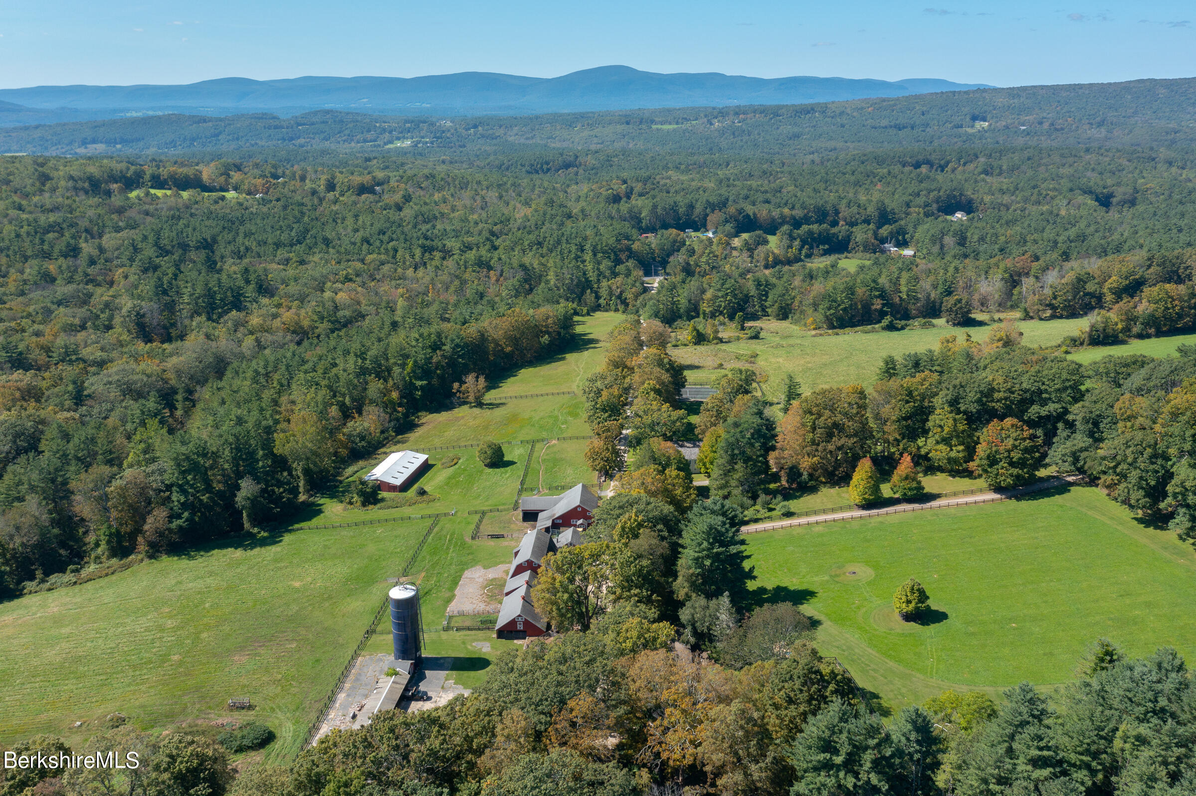 185 Keyes Hill Road New Marlborough, MA 01259 - Photo 6 of 49 an aerial view of green landscape with trees houses and mountain view