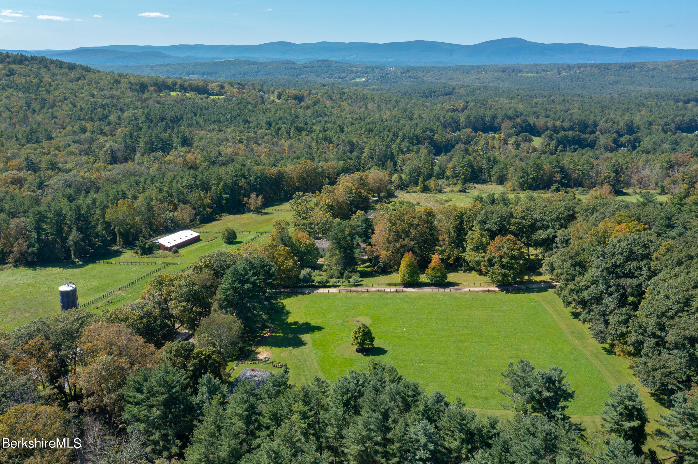 185 Keyes Hill Road New Marlborough, MA 01259 - Photo 10 of 49 an aerial view of green landscape with trees houses and mountain view