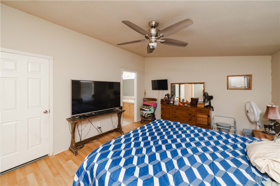4729 Stewart Mountain Road Golden Valley, AZ 86413 - Photo 12 of 28 a bedroom with a bed and flat screen tv