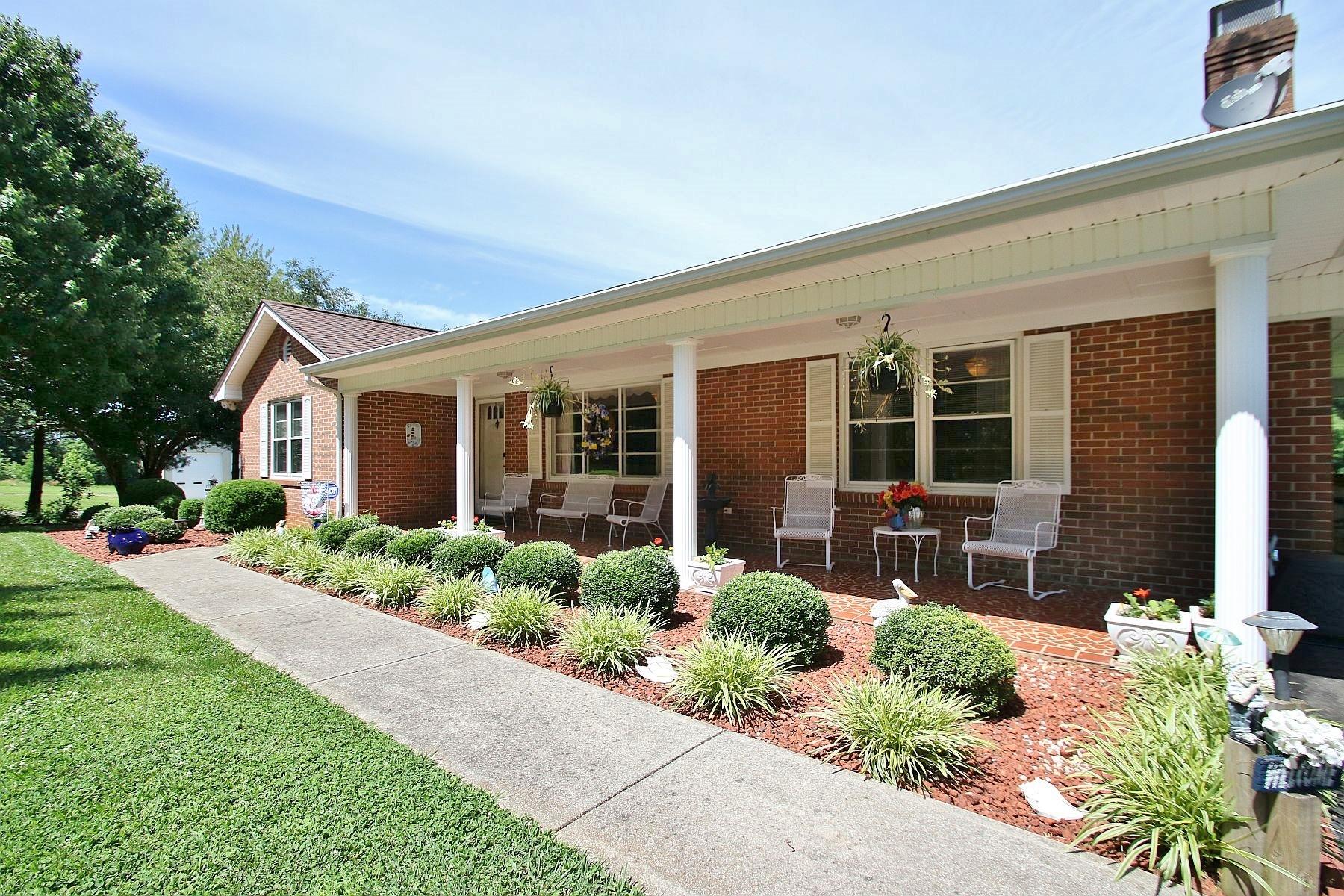 a front view of a house with a yard and potted plants