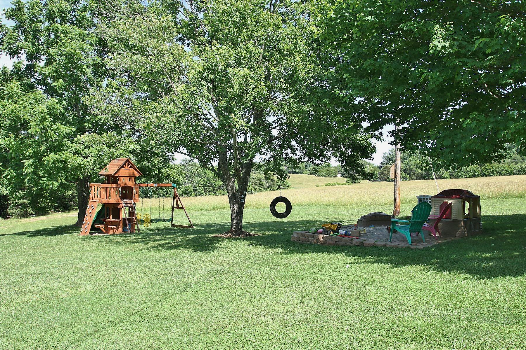 164 Standiford Road Union Hall, VA 24176 - Photo 39 of 40 a backyard of a house with childrens swings and slides