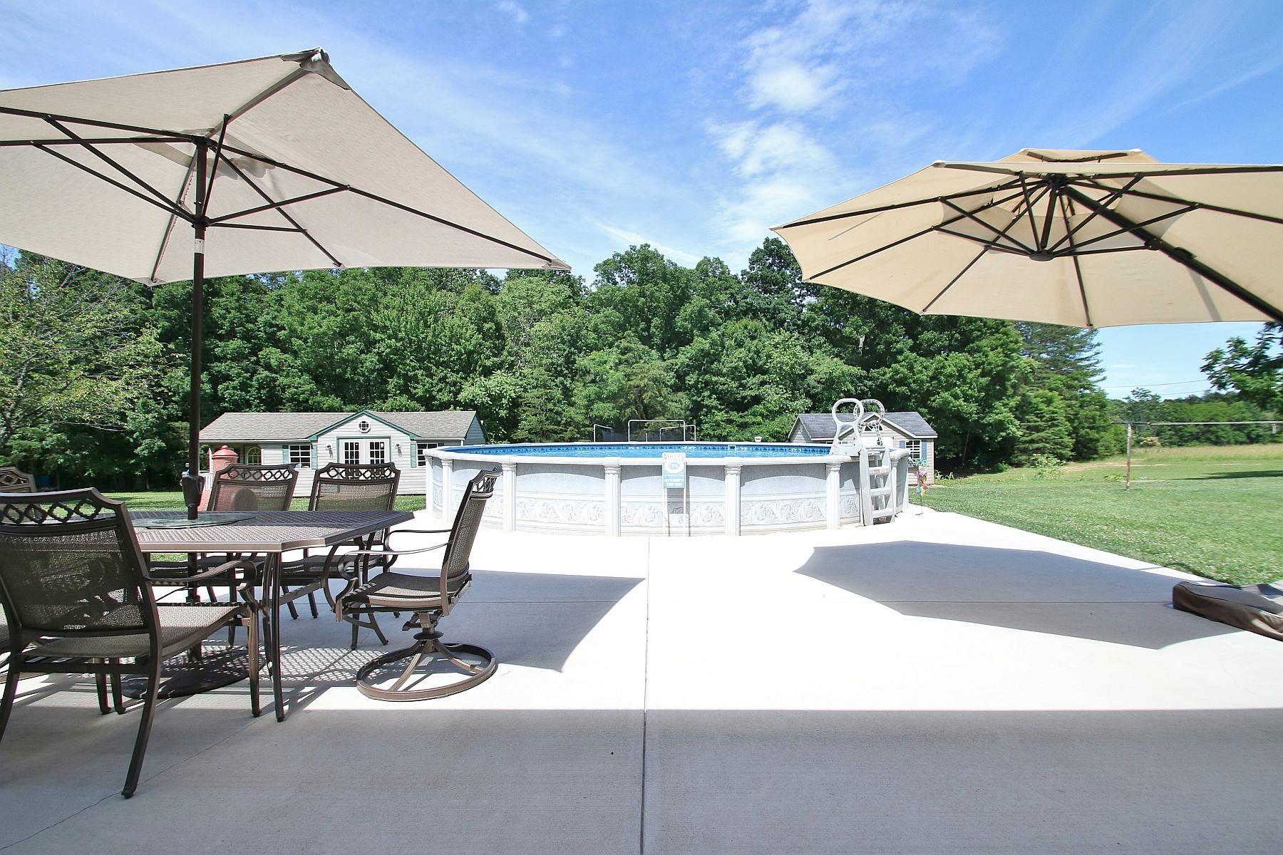 164 Standiford Road Union Hall, VA 24176 - Photo 8 of 40 a view of a patio with a table and chairs under an umbrella