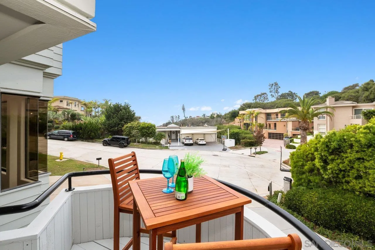 6105 Avenida Chamnez La Jolla, CA 92037 - Photo 18 of 59 a view of a patio with couches table and chairs under an umbrella