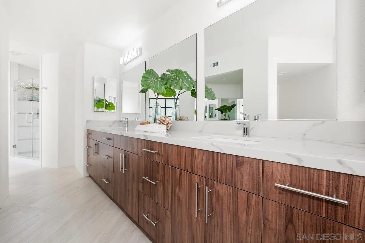 6105 Avenida Chamnez La Jolla, CA 92037 - Photo 32 of 59 a bathroom with a sink and a mirror