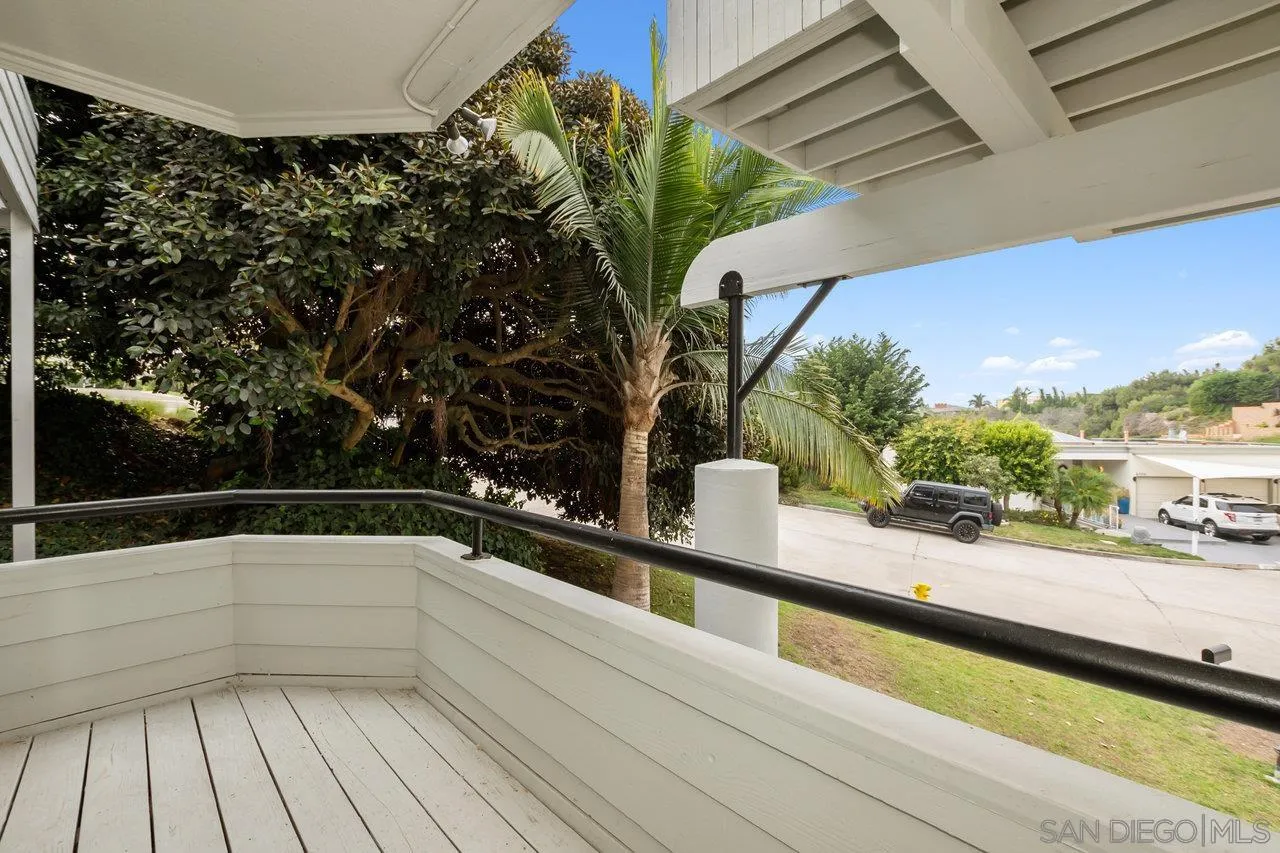 6105 Avenida Chamnez La Jolla, CA 92037 - Photo 50 of 59 a view of a balcony with floor to ceiling windows and wooden floor
