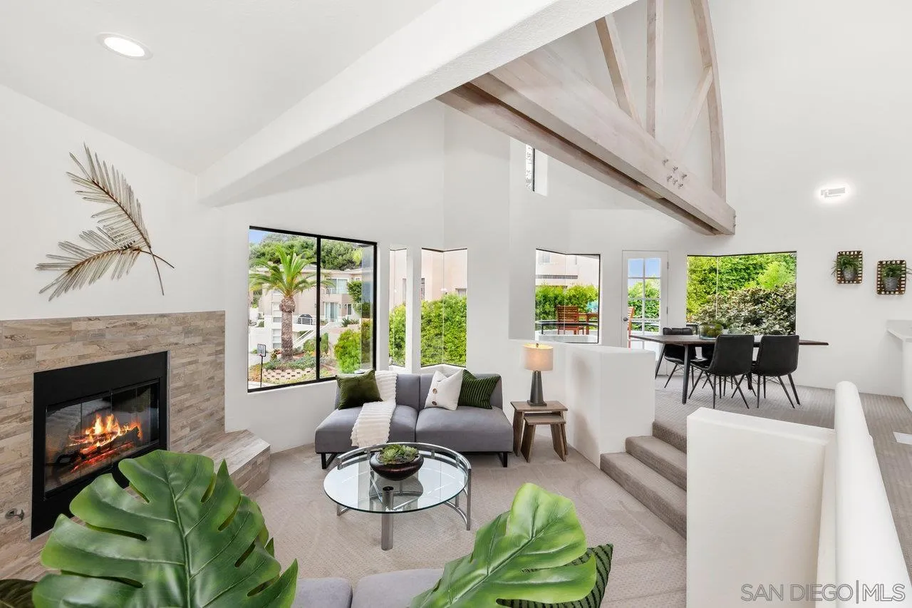 6105 Avenida Chamnez La Jolla, CA 92037 - Photo 7 of 59 a living room with furniture a fireplace and a large window