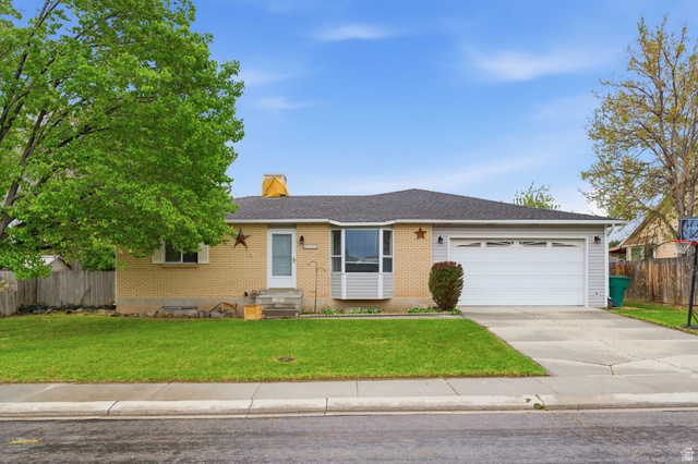 2093 West 7420th Street South West Jordan, UT 84084 - Photo 1 of 1 Single story home featuring brick siding, concrete driveway, an attached garage, a shingled roof, and a chimney