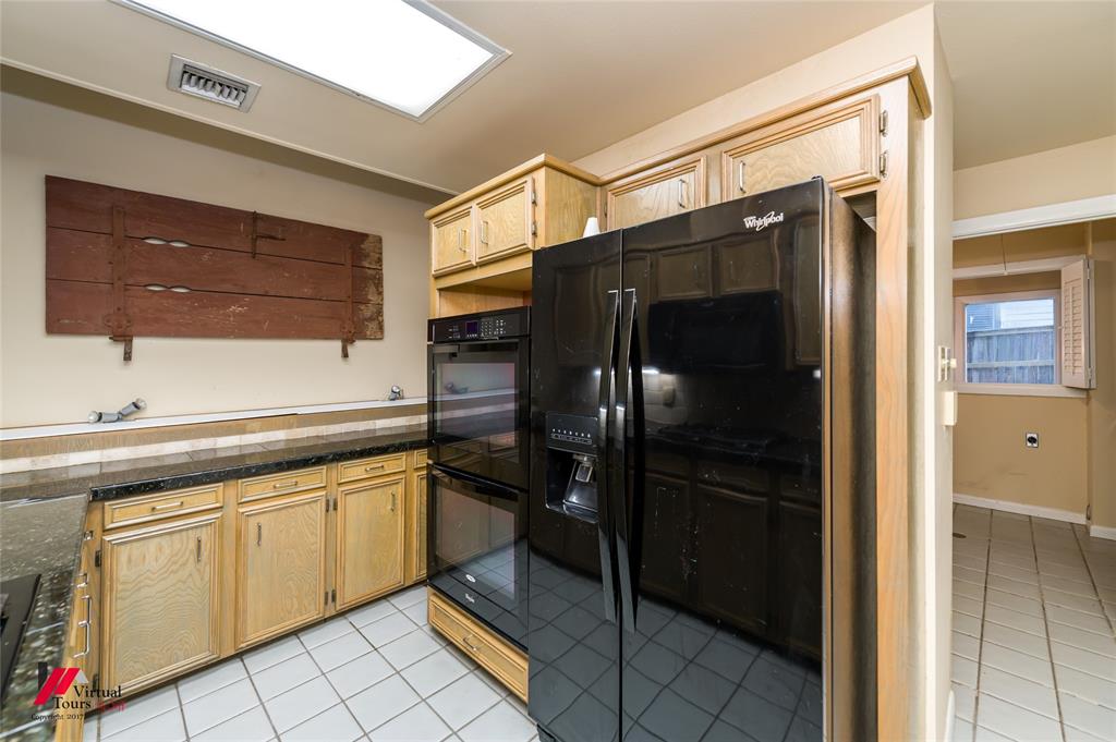 300 Pierremont Road, Unit 40 Shreveport, LA 71106 - Photo 14 of 34 Kitchen featuring light wood cabinetry, black appliances, dark countertops, and tile flooring